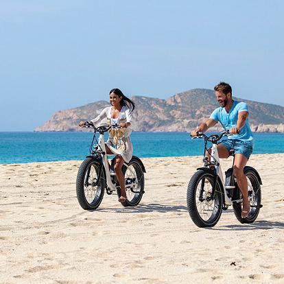 a couple riding bike at garza blanca los cabos